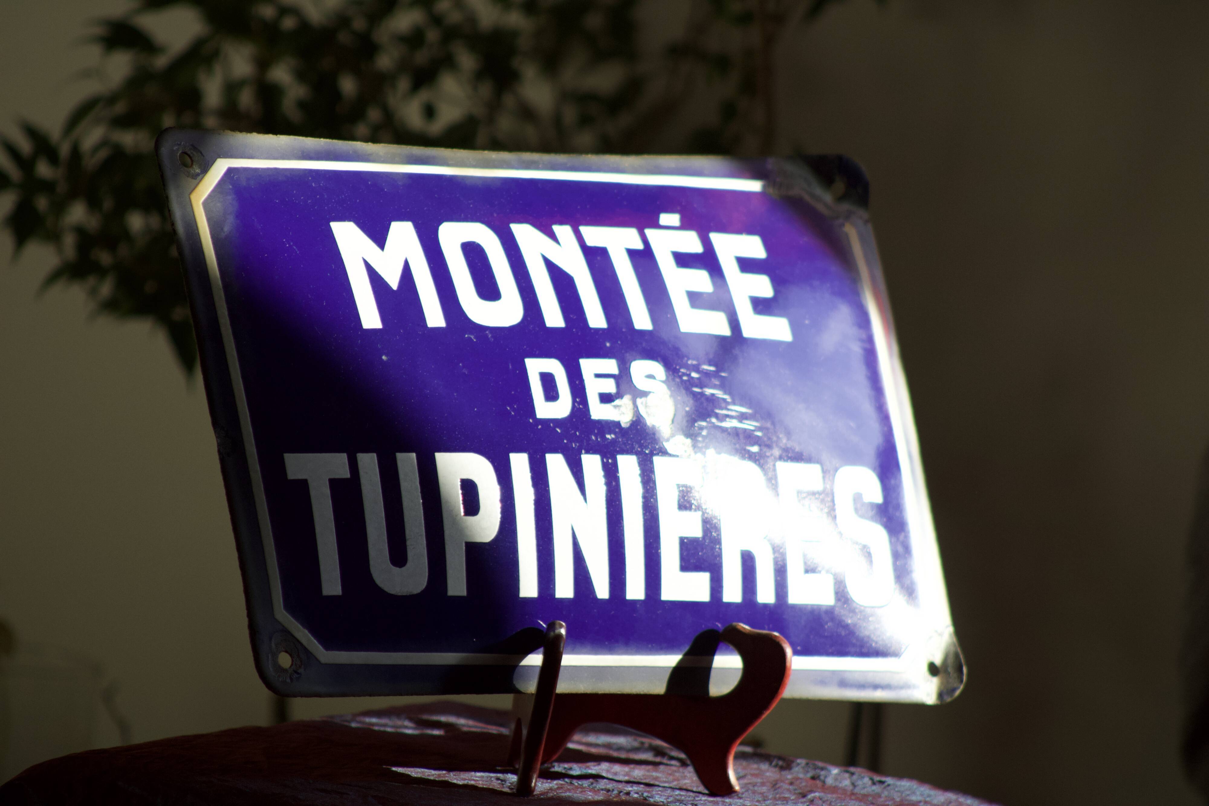Former French street name plaque in bulging enamel led sheet "Montée des Tupinieres"