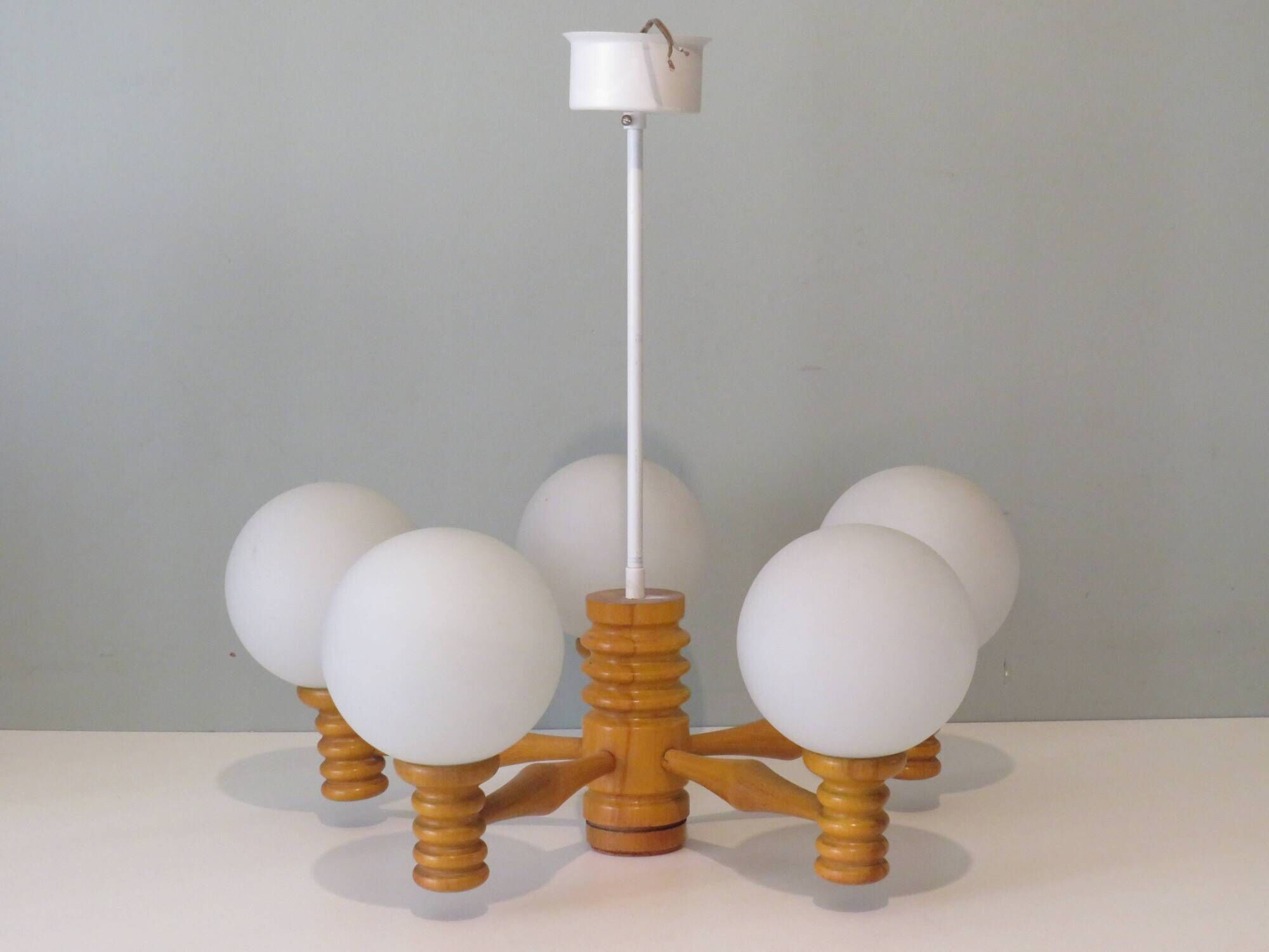 Space age chandelier in 5-arm wood with white frosted opaline glass spheres.