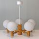 Space age chandelier in 5-arm wood with white frosted opaline glass spheres.