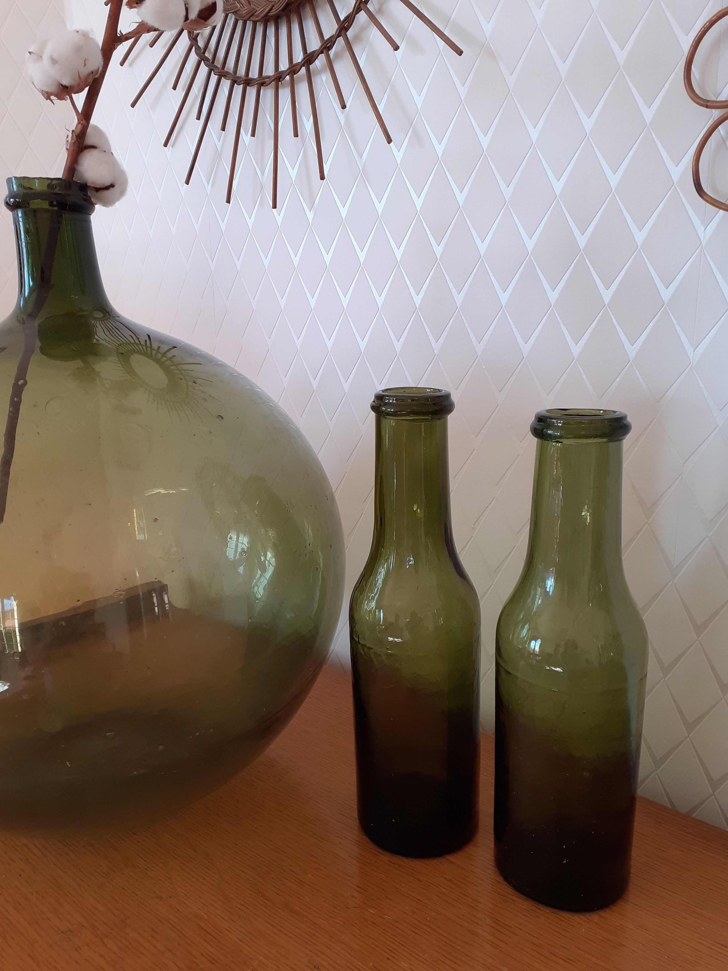Pair of green bottles made of bubbled blown glass