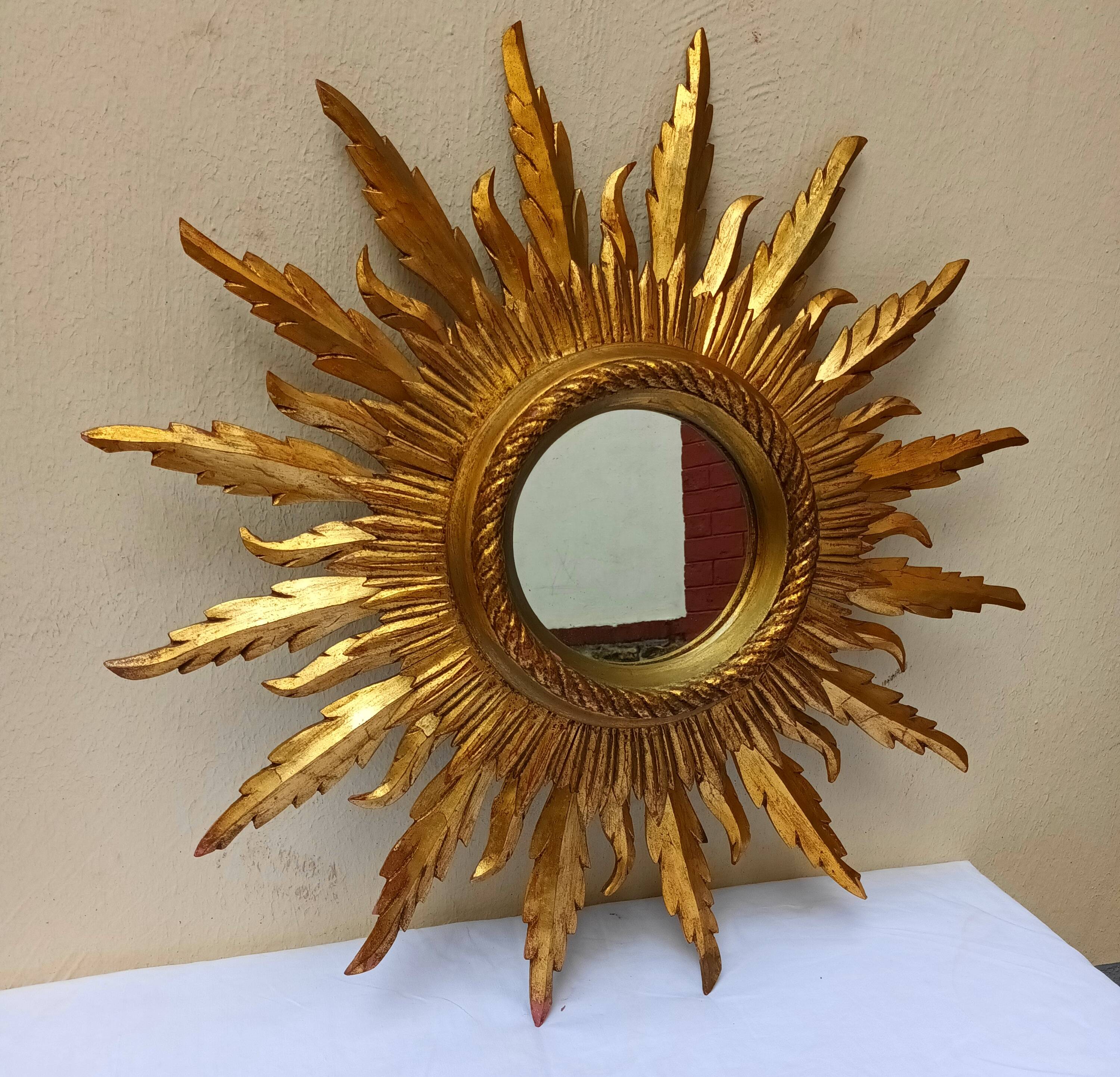Sun mirror in carved gilded wood from the 1950s