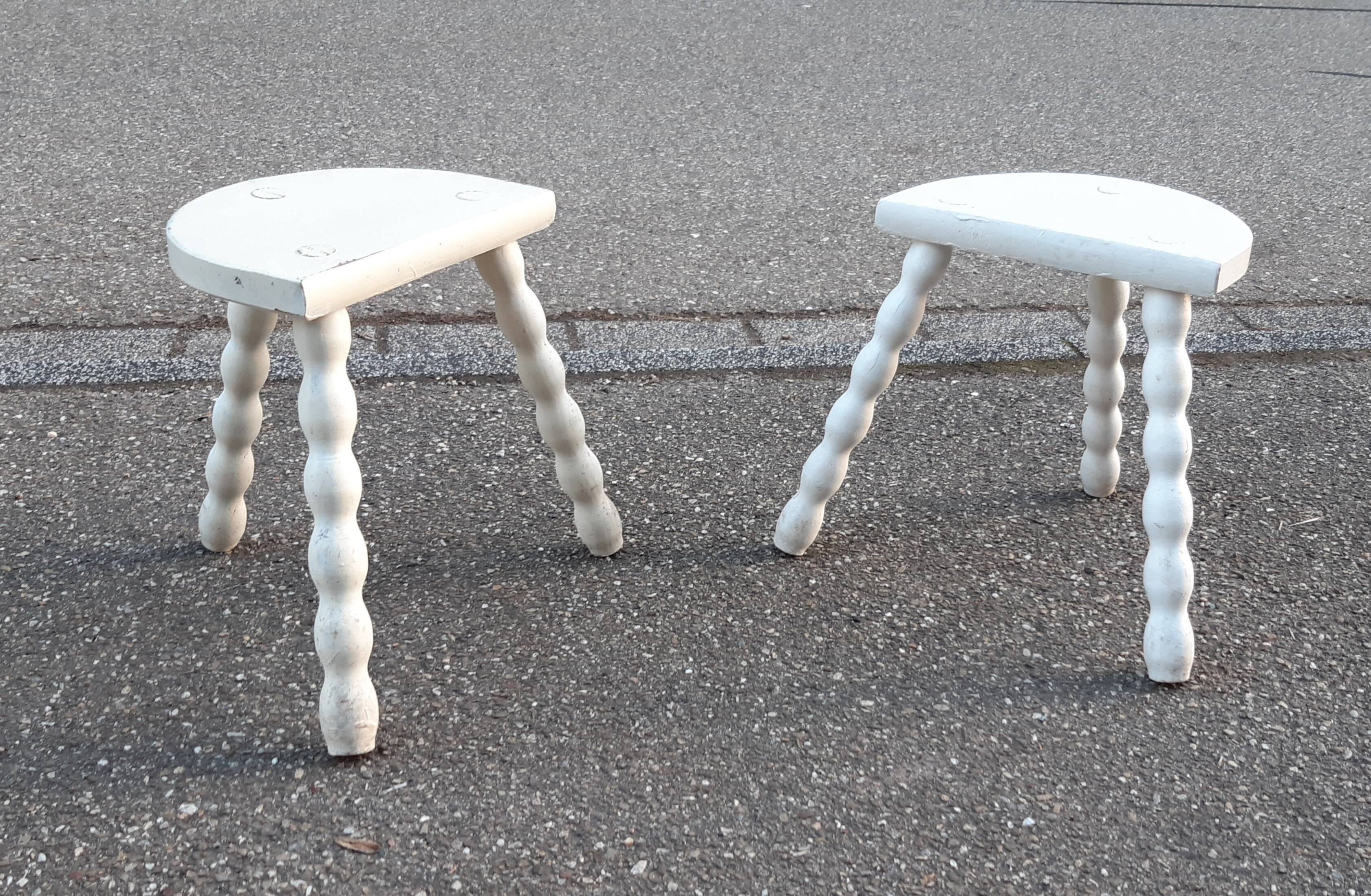 Duo of milking stools with turned legs.