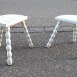 Duo of milking stools with turned legs.