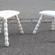 Duo of milking stools with turned legs.