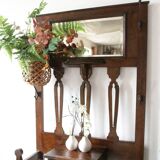 Antique brown wooden coat rack with mirror and umbrella stand, 1900 style.