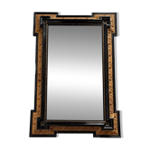 Antique wall mirror in blackened wood and gilded stucco, 19th-century Dutch style.