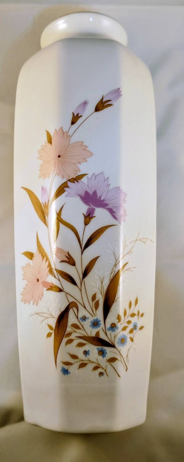 White ceramic vase with floral patterns