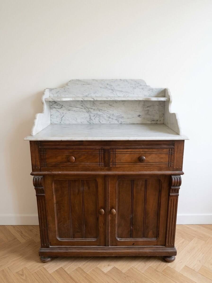 Antique wooden chest of drawers with a marble top.