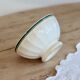 Old ivory ceramic bowl with double green trim.