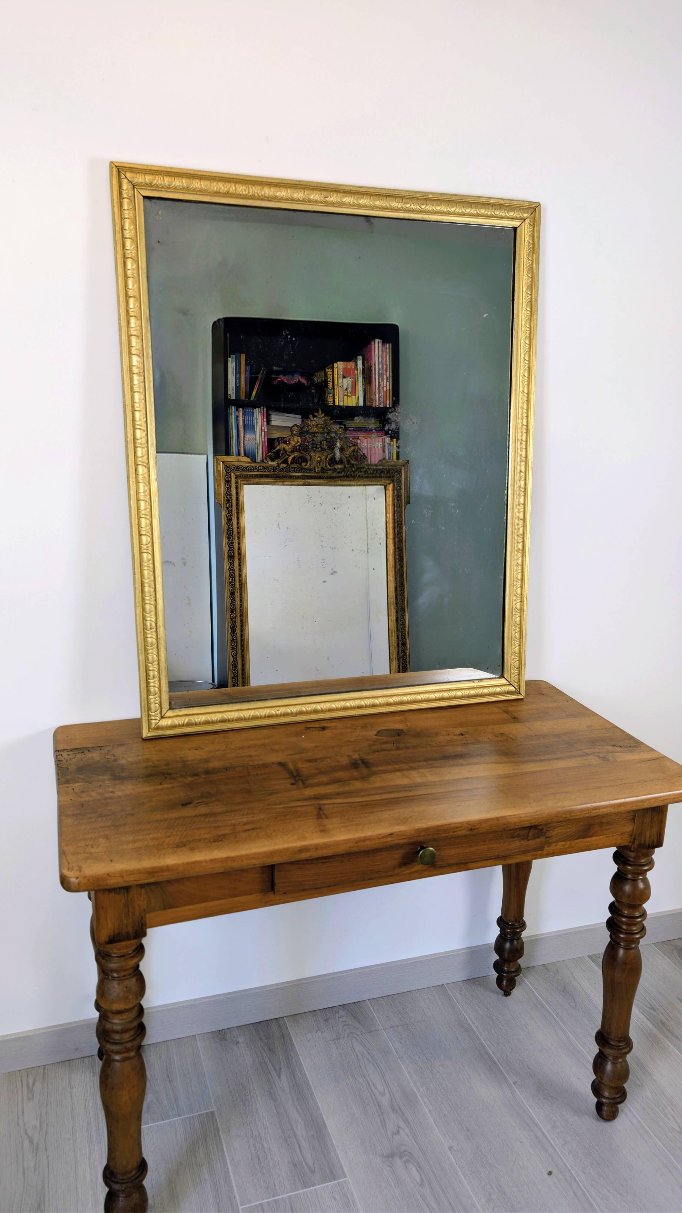 Antique writing table in the Napoleon III style with turned wooden legs.