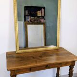 Antique writing table in the Napoleon III style with turned wooden legs.