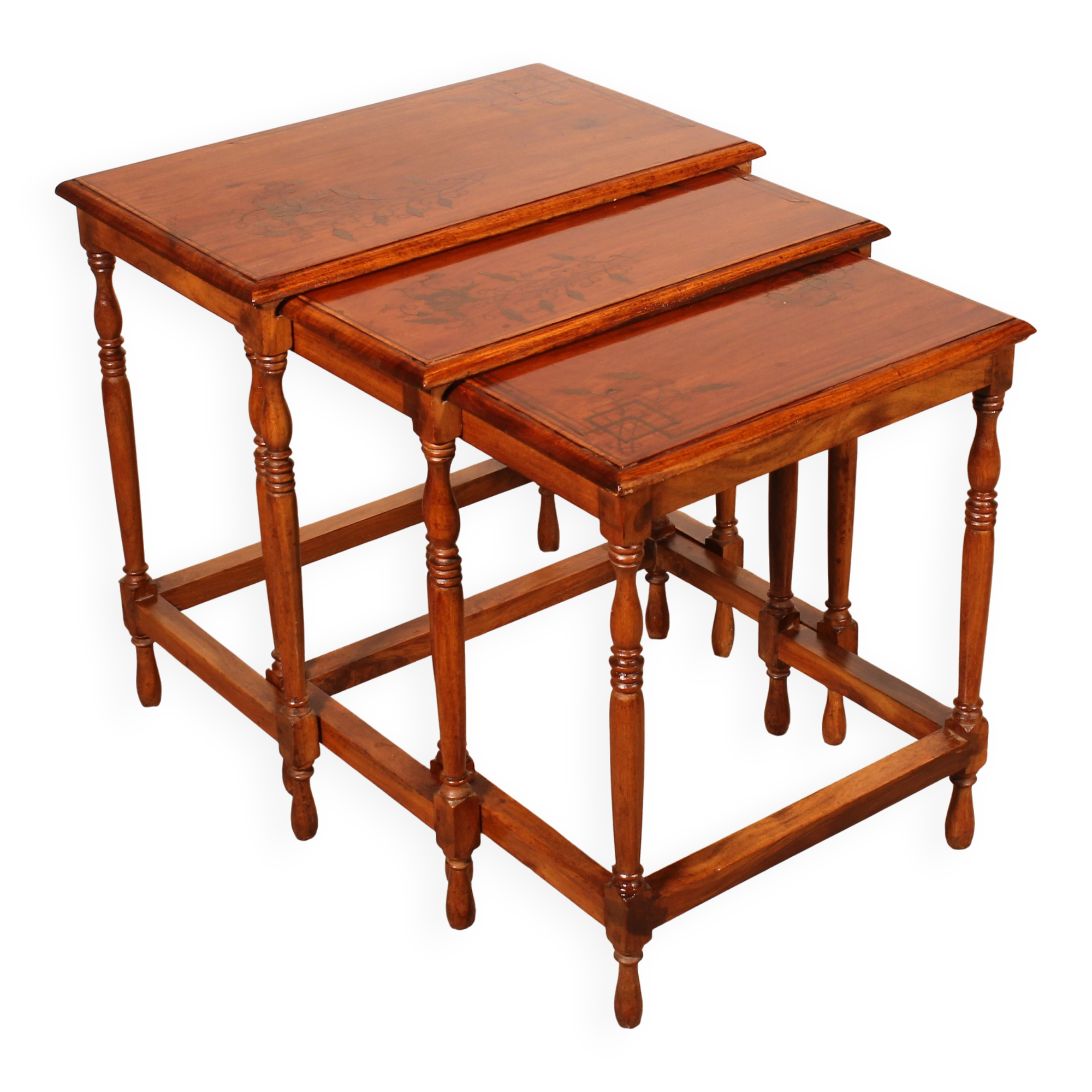 Nested tables in satin wood with brass inlays.