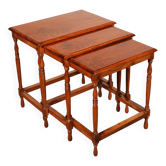 Nested tables in satin wood with brass inlays.