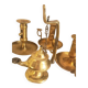 Many candlesticks and a small oil lamp.
