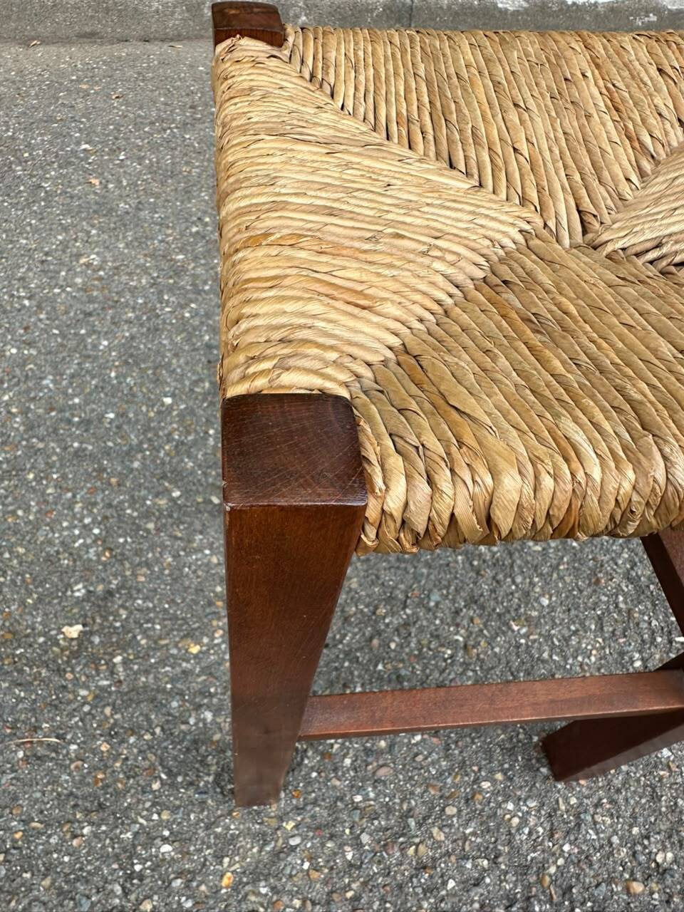Low stool in brutalist style made of solid wood with straw, 1980.