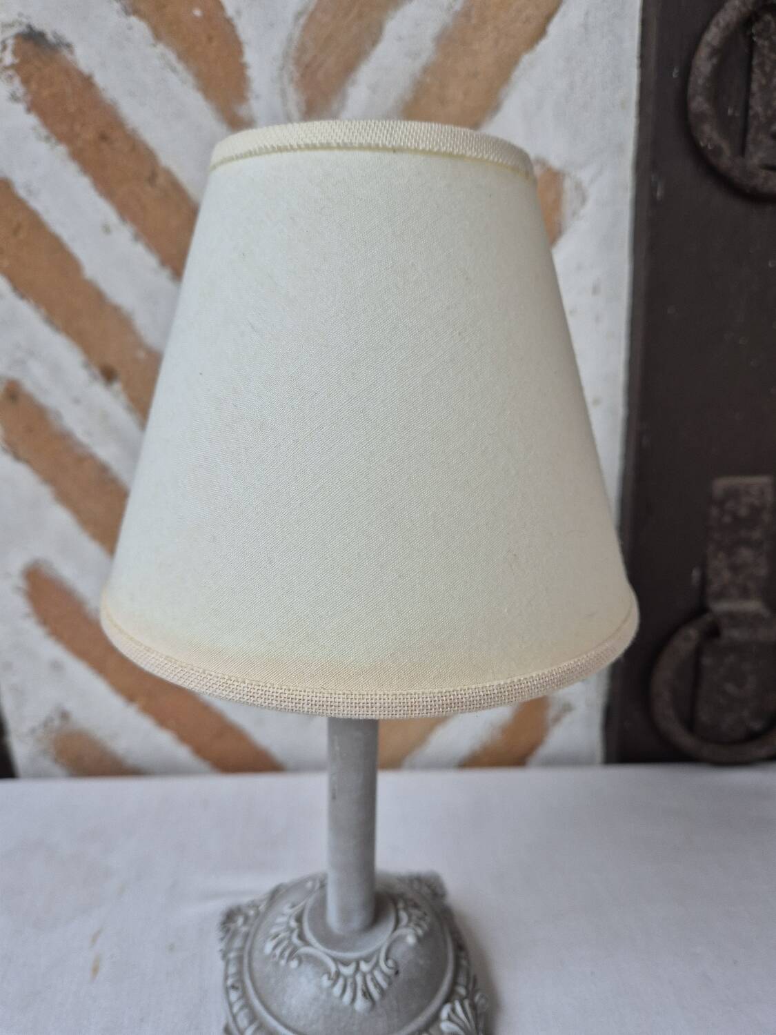 Patinated taupe bedside lamp