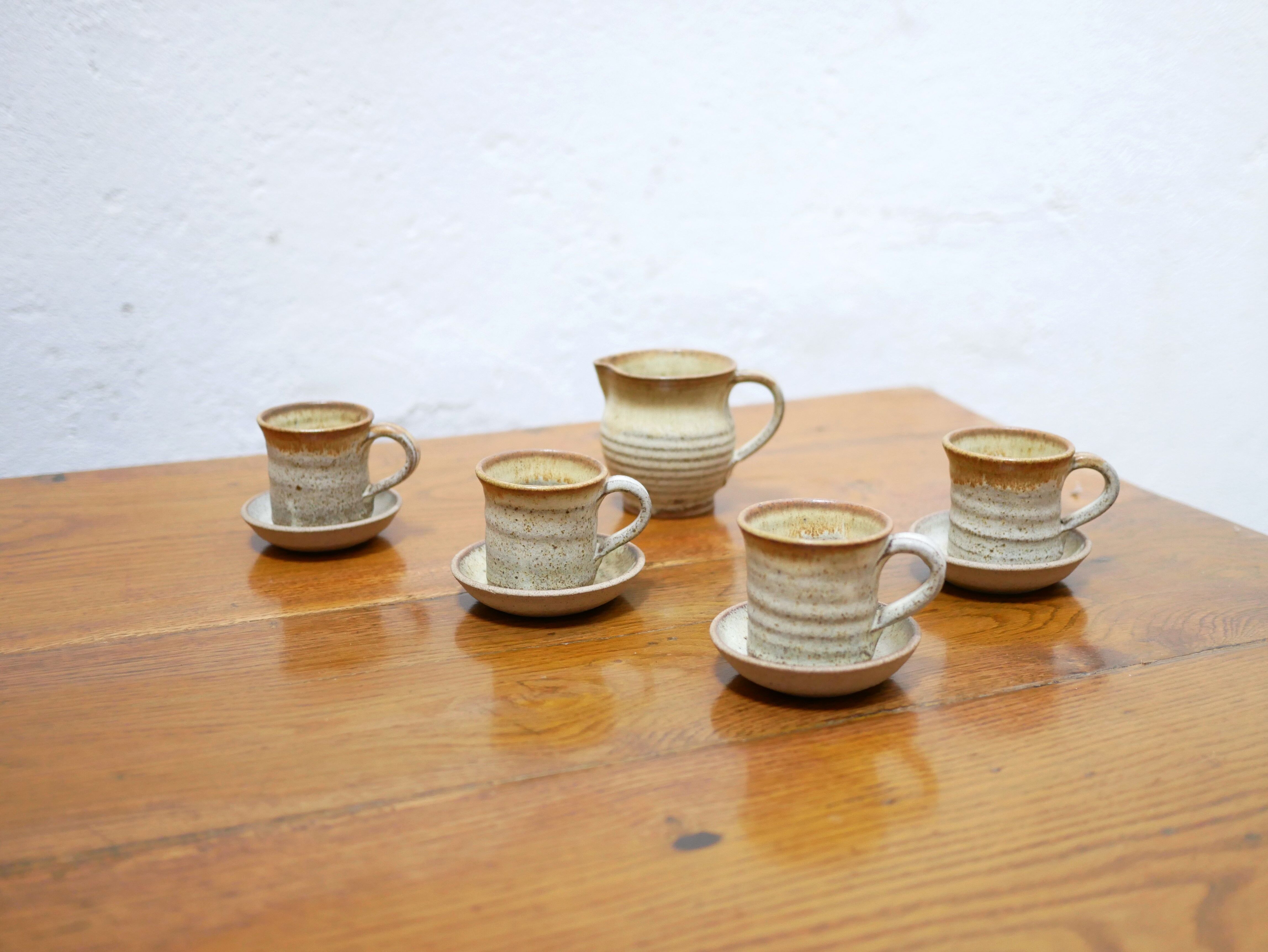 Series of 4 cups and a vintage stoneware milk jug