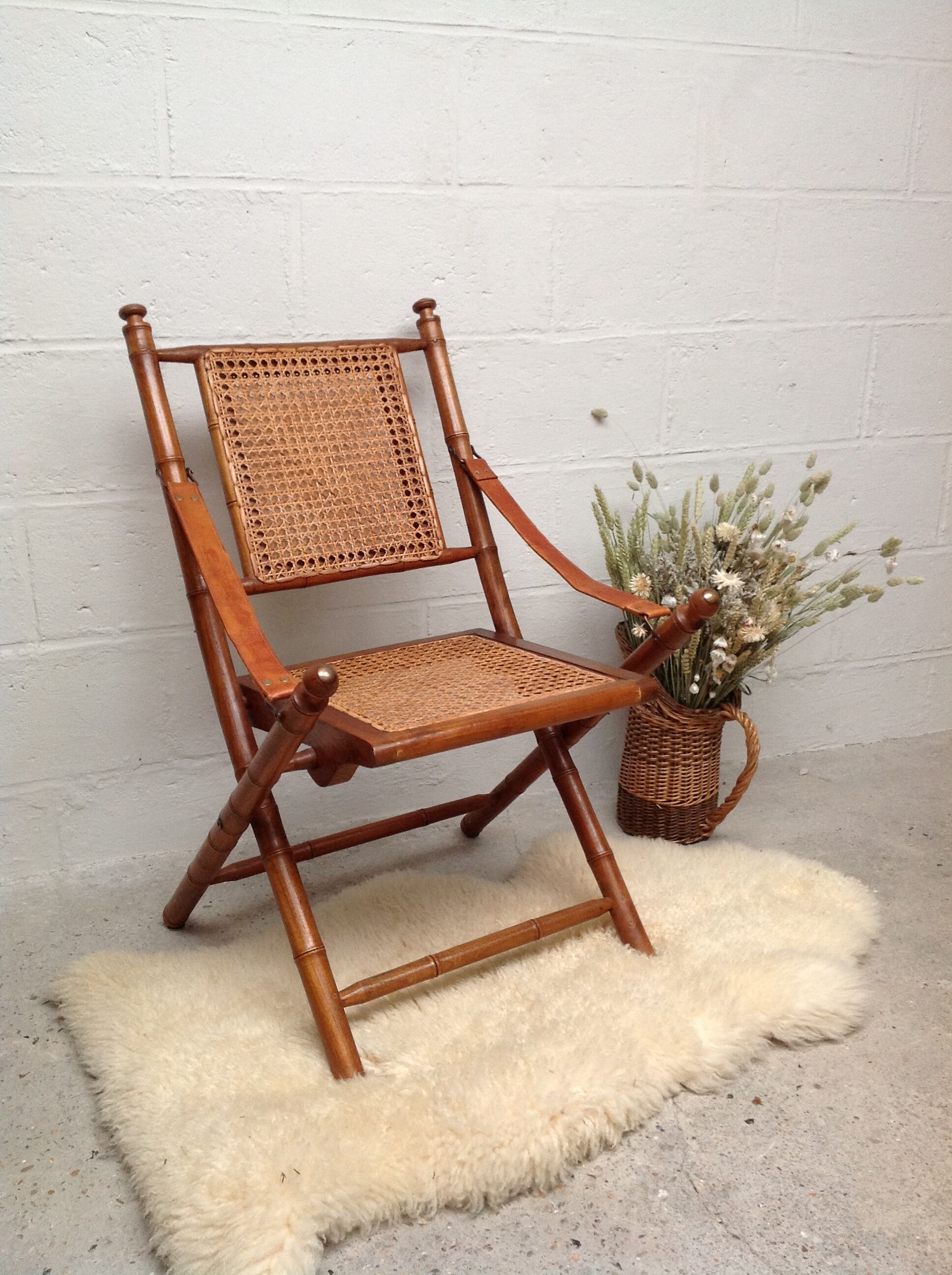Bamboo folding armchair and caning, leather and brass
