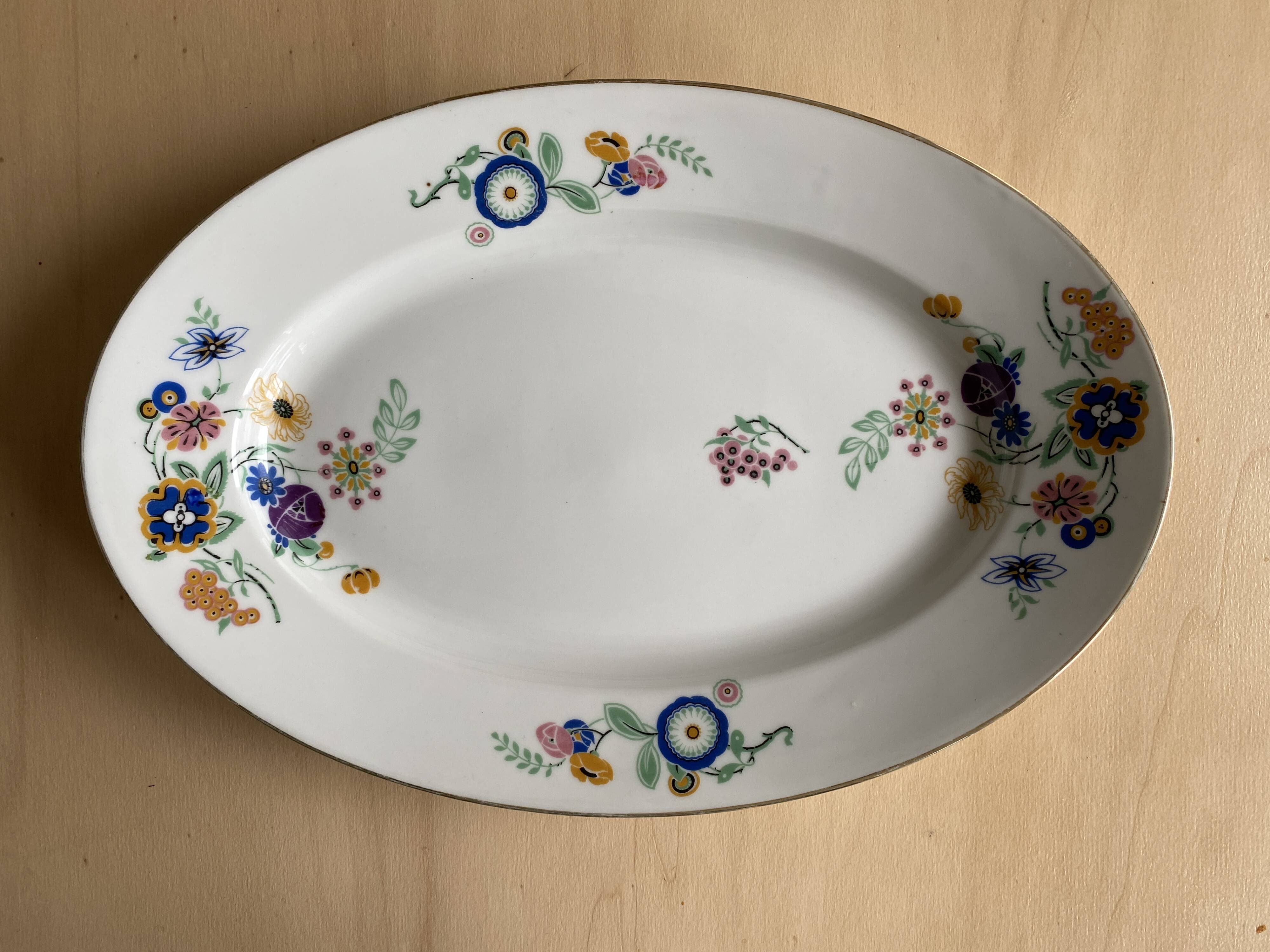 Oval vintage plate in white Limoges porcelain signed T.L.B flowers.