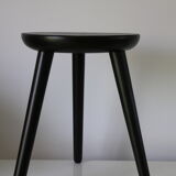 Black tripod wooden stool