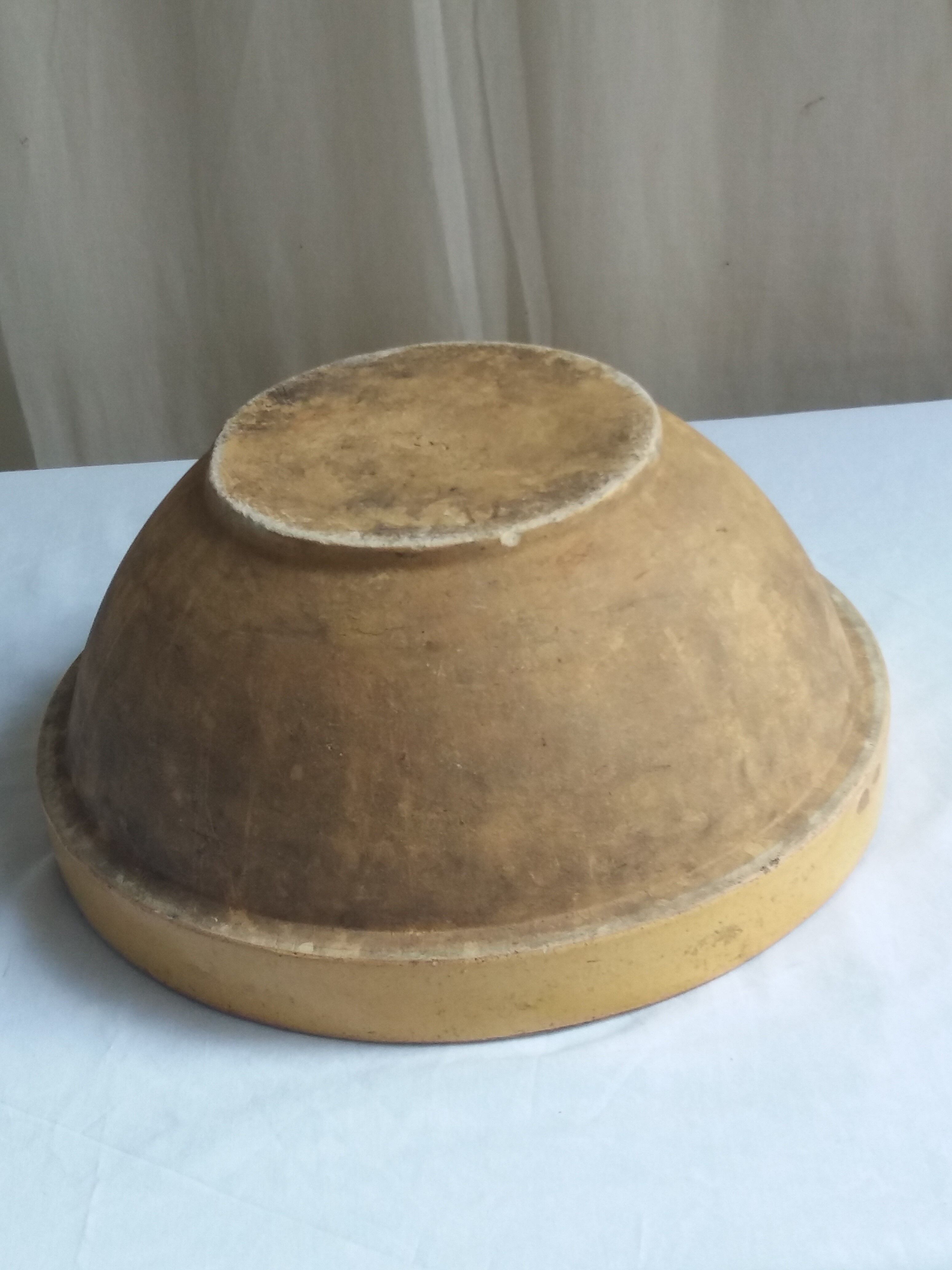 Large old salad bowl in yellow varnished earth