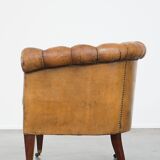 Fauteuil chesterfield sur roulettes en cuir de mouton