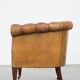 Antique, characteristic sheepskin chesterfield club chair on wheels