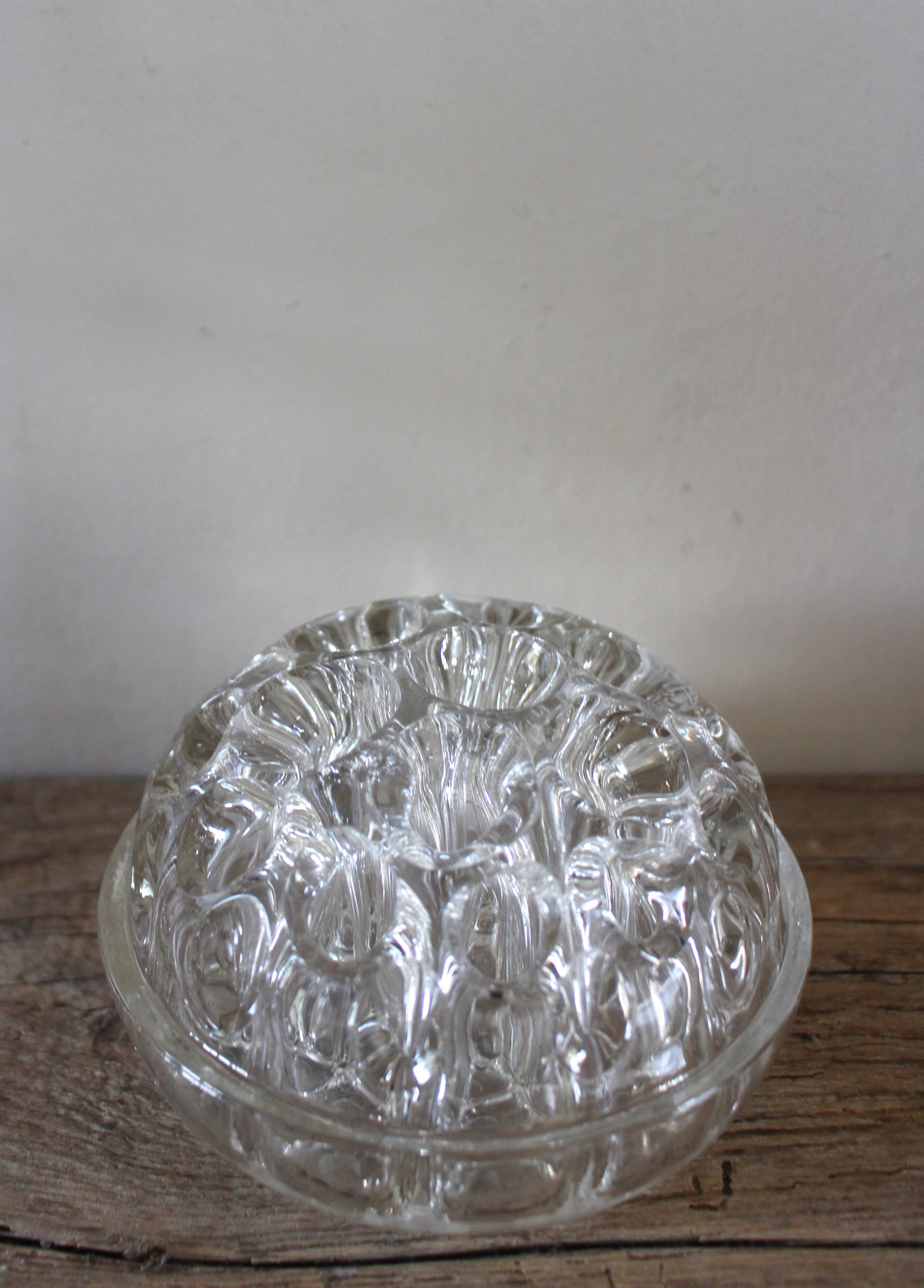 Large round glass flower frog vase with 19 holes.
