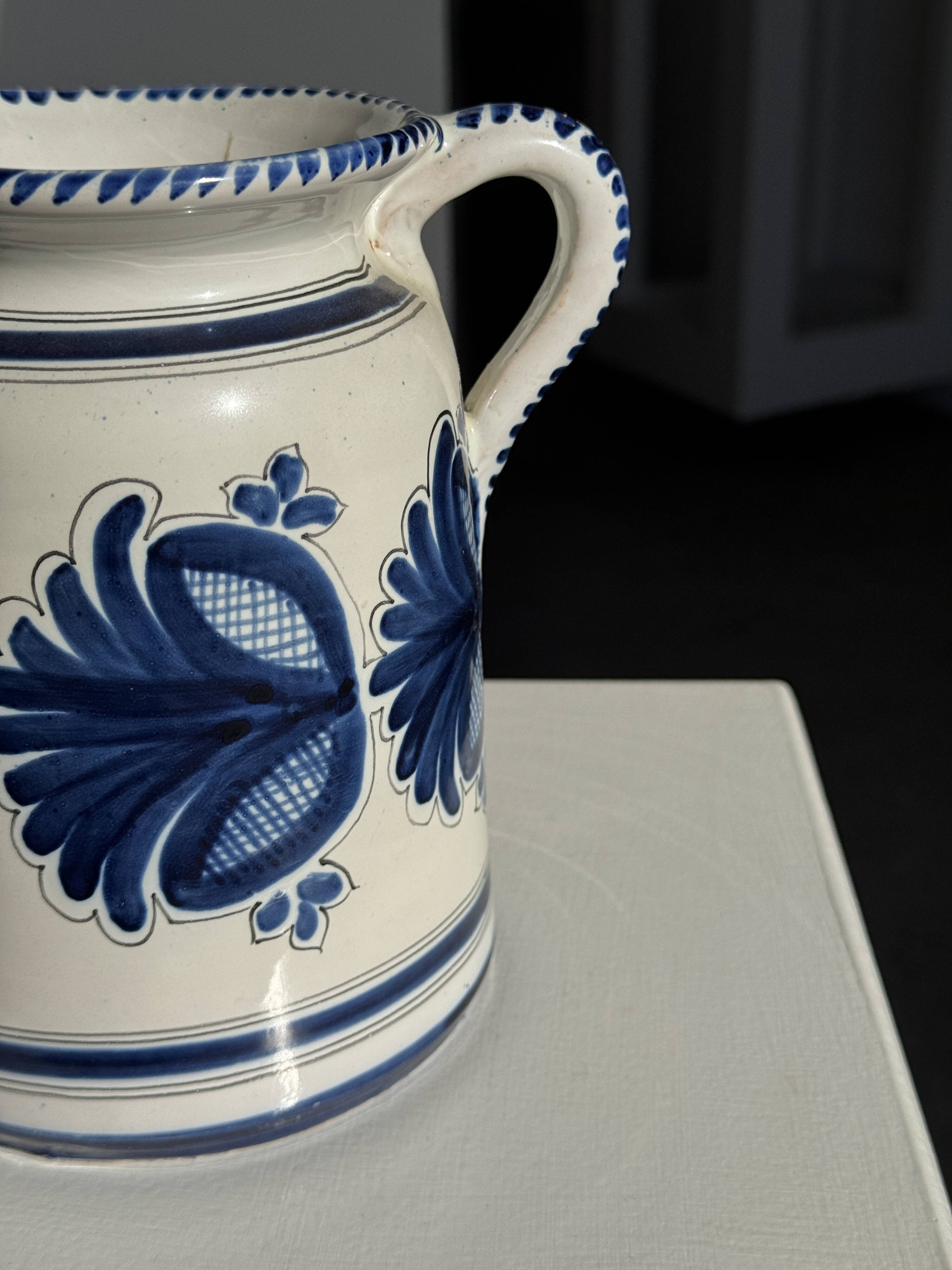 Artisan blue floral decorative carafe, height 17 cm, diameter 24.5 cm.