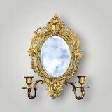 Antique bronze wall sconce with two candlesticks and beveled mirror