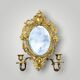 Antique bronze wall sconce with two candlesticks and beveled mirror