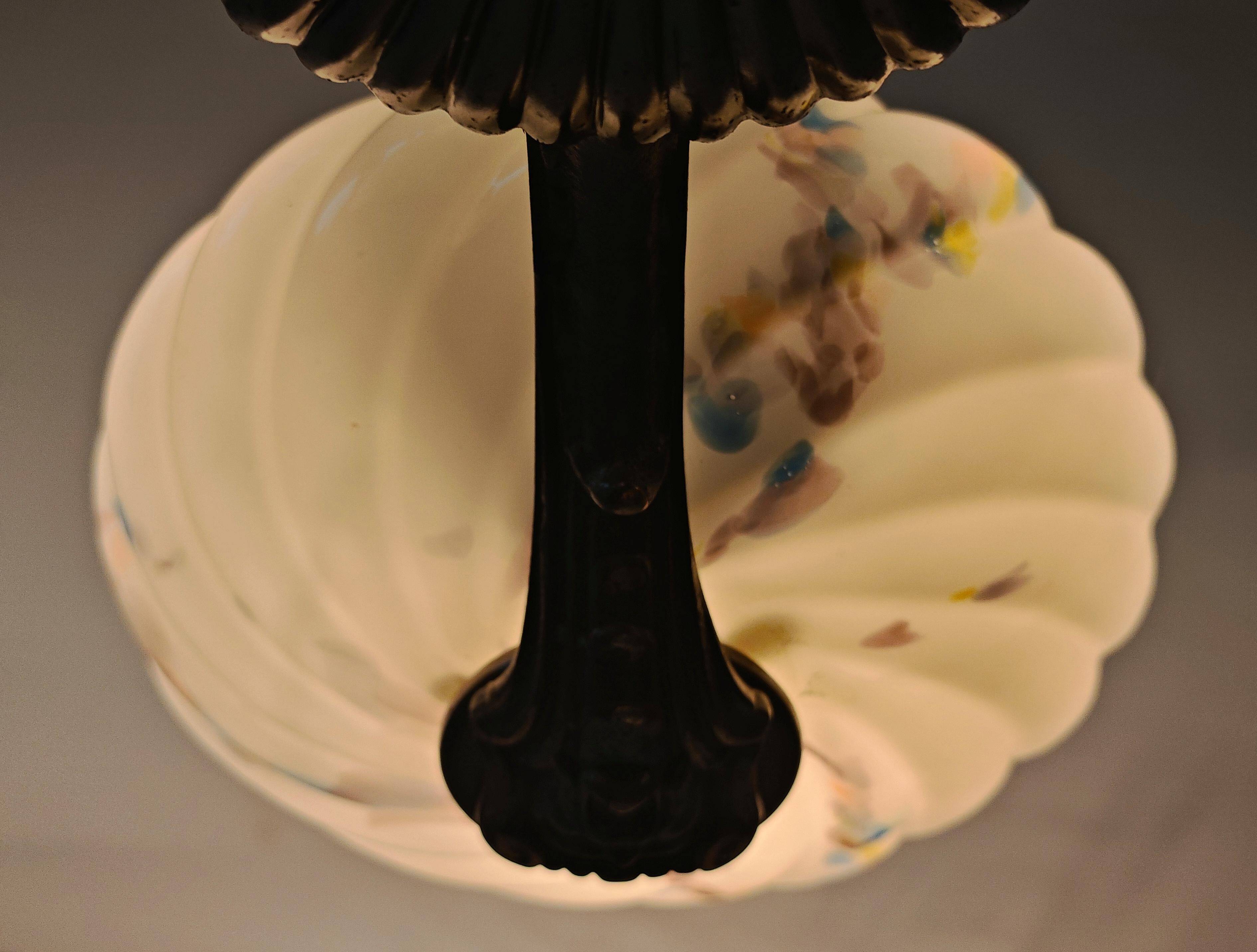 Art Deco bronze three-arm chandelier with marbled glass shades.