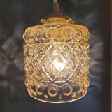 Moulded glass lamp with a cubic-spherical relief design.