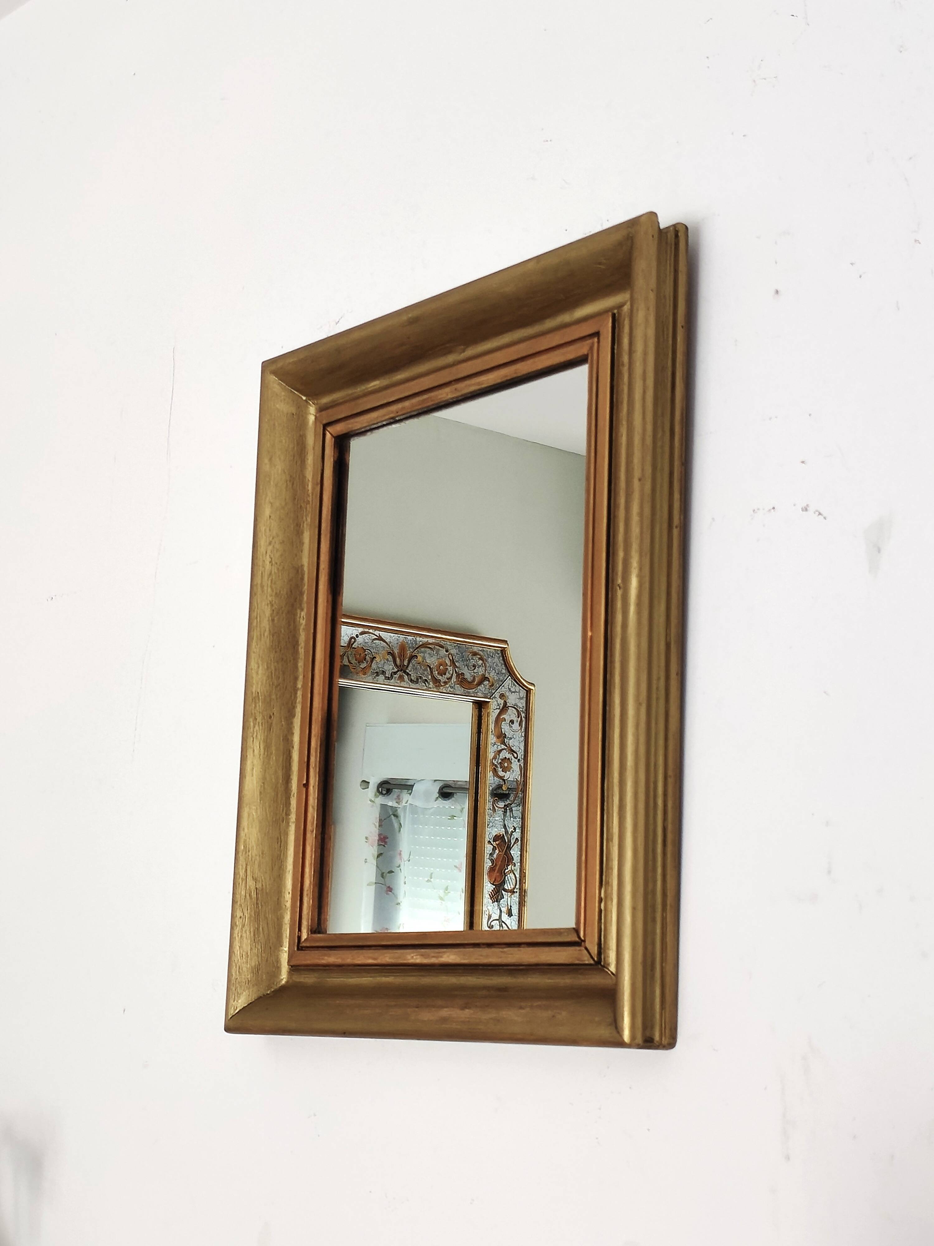 Antique mirror in gilded and copper wood