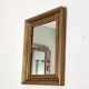 Antique mirror in gilded and copper wood