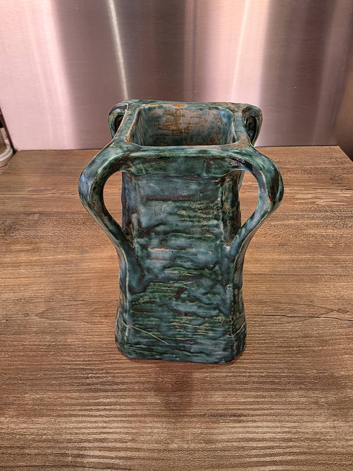 Vintage brutalist ceramic vase with 4 green handles.