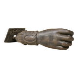 Antique cast iron door knocker in the shape of a 19th century hand