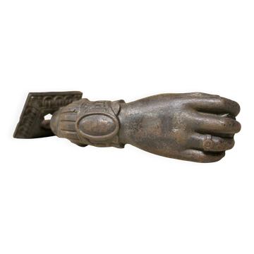 Antique cast iron door knocker in the shape of a 19th century hand