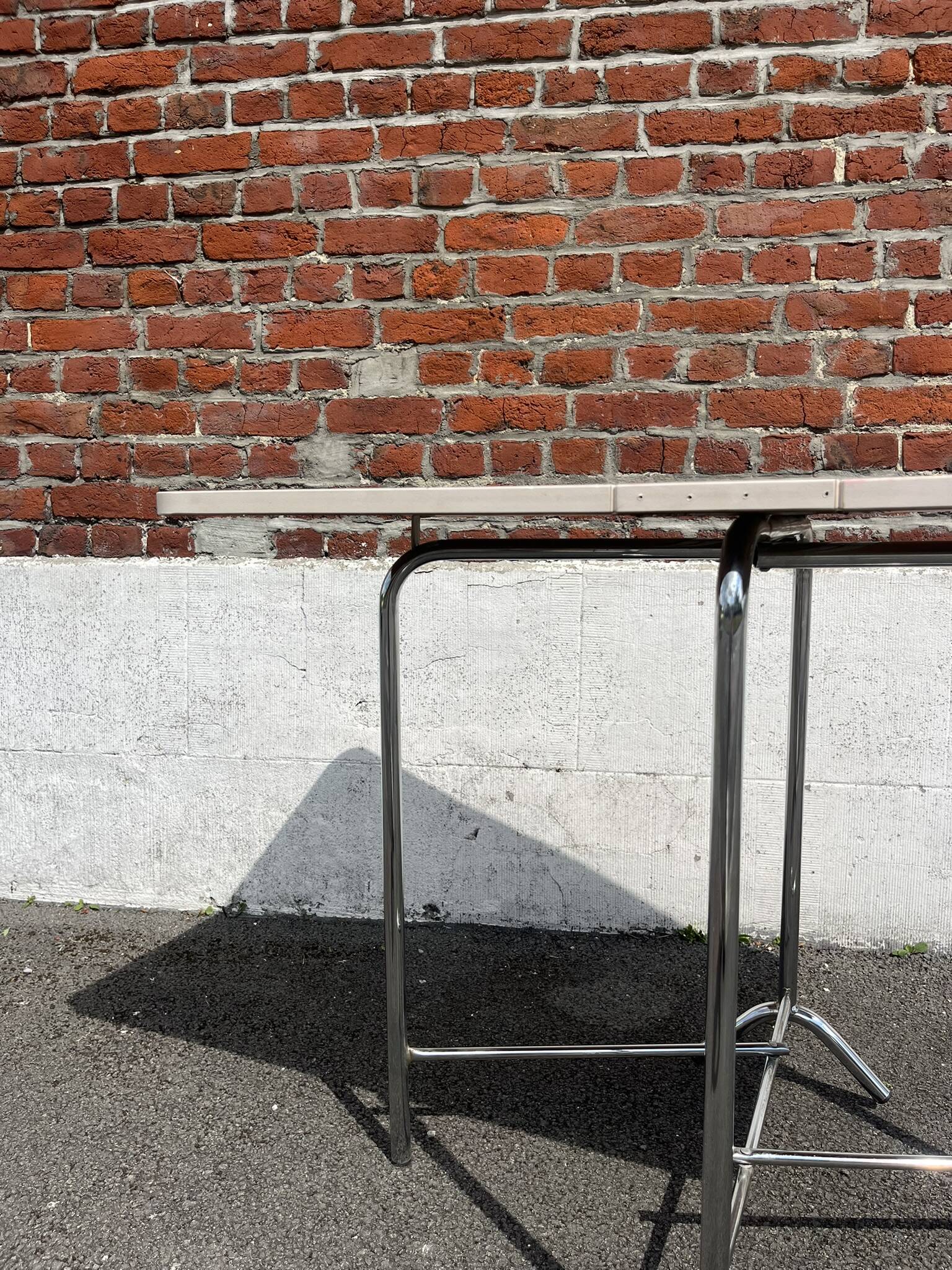 Folding table with chrome and pink formica.