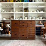 Craftsman's cabinet with 16 drawers in dark wood.