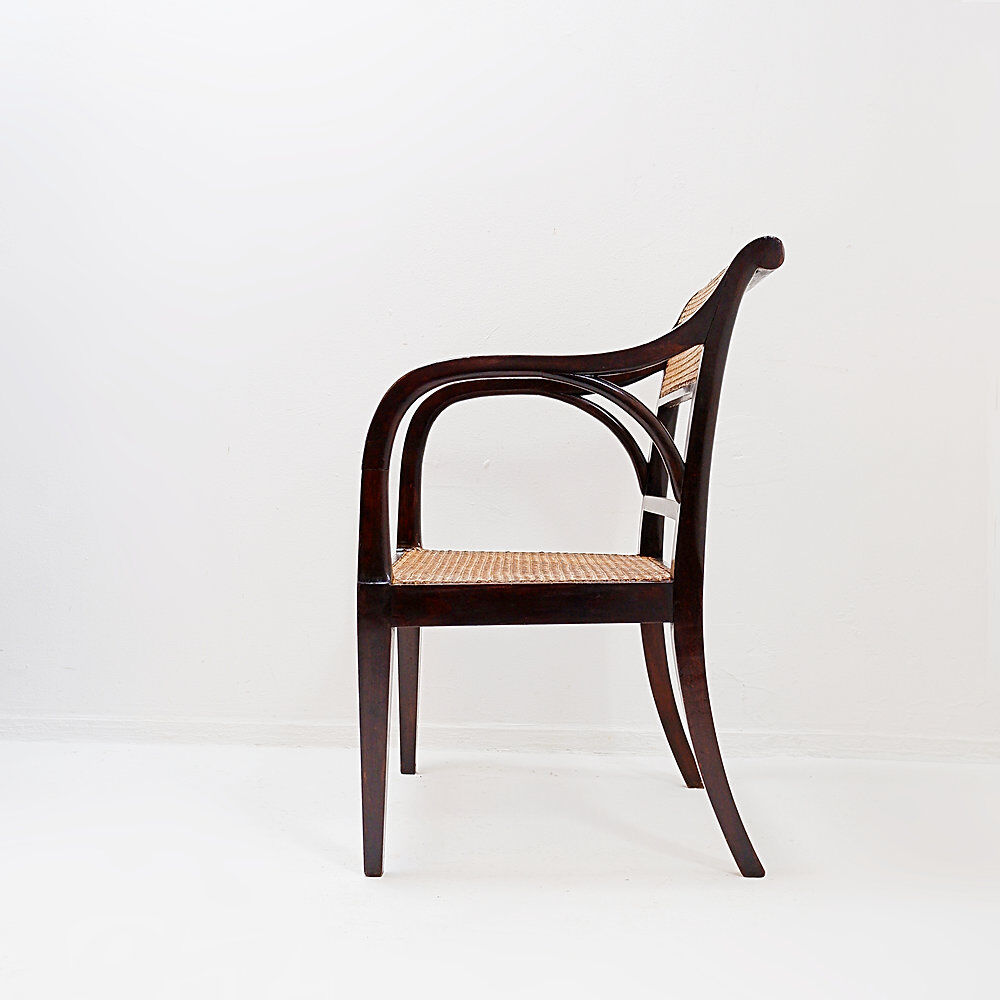 Mid-century curved wooden chairs with cane seats and backs.
