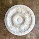 Rosette on white background, decorated with scrolls and beaded frieze ⌀ 61 cm