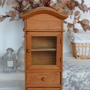 Vintage wooden shelf with drawers and mesh door.