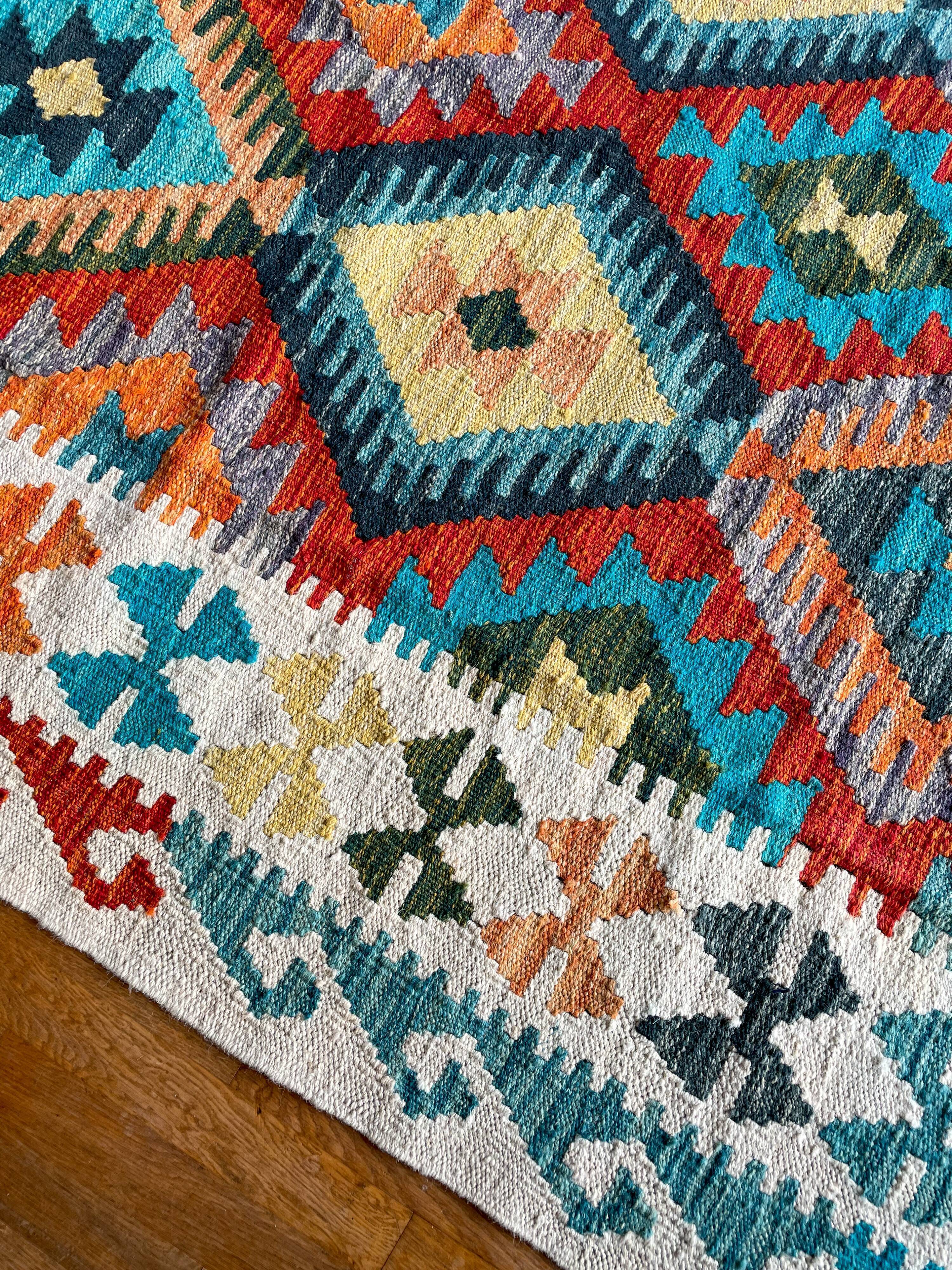 Oriental kilim rug afghan colored red and multicolored