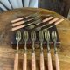 Dessert forks in brass and Bakelite in their case.