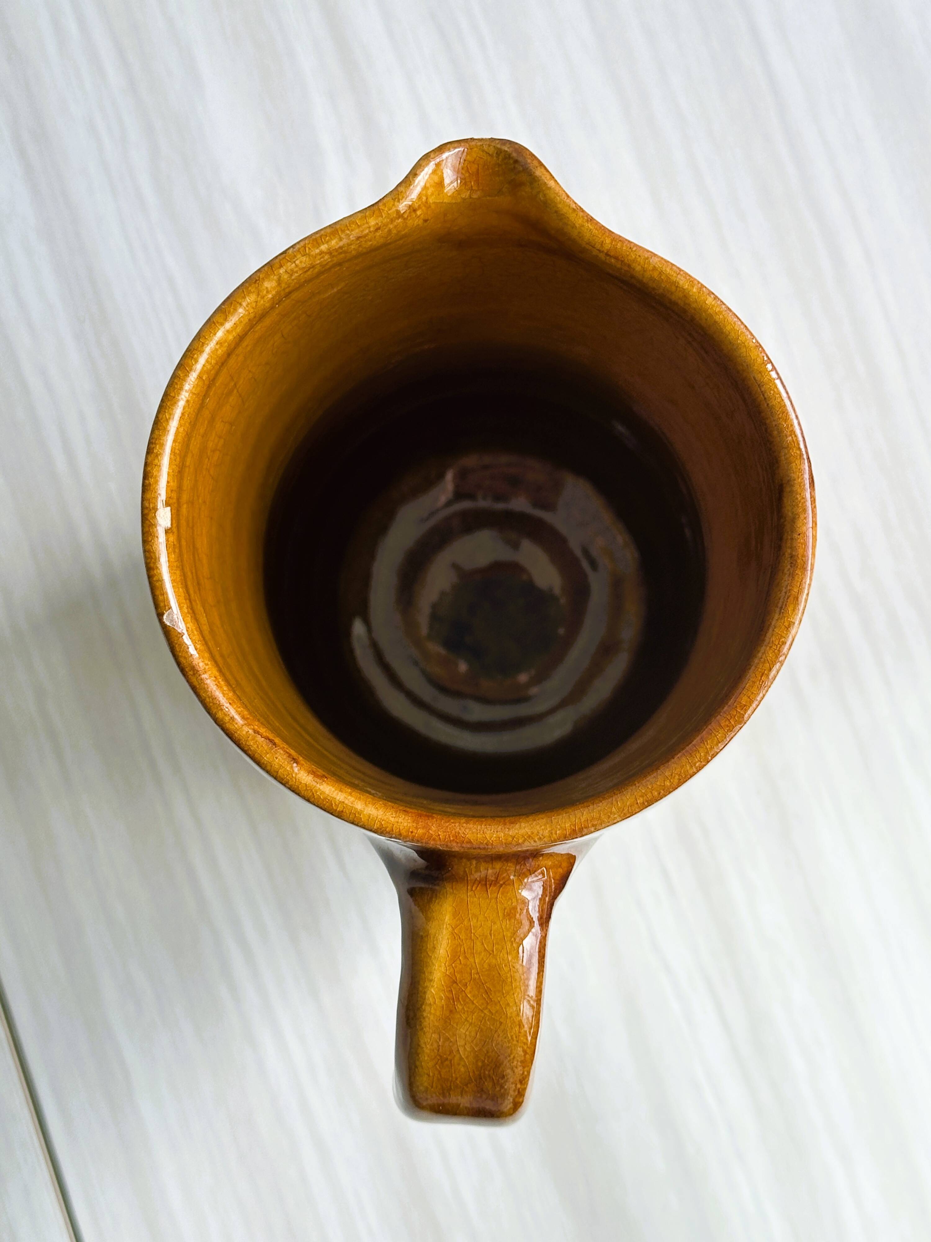 Vintage enameled ceramic watering can vase - retro mustard yellow pot.