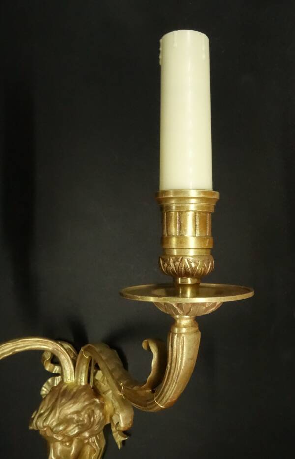 Large pair of wall sconces with male faces in Louis XVI style - bronze