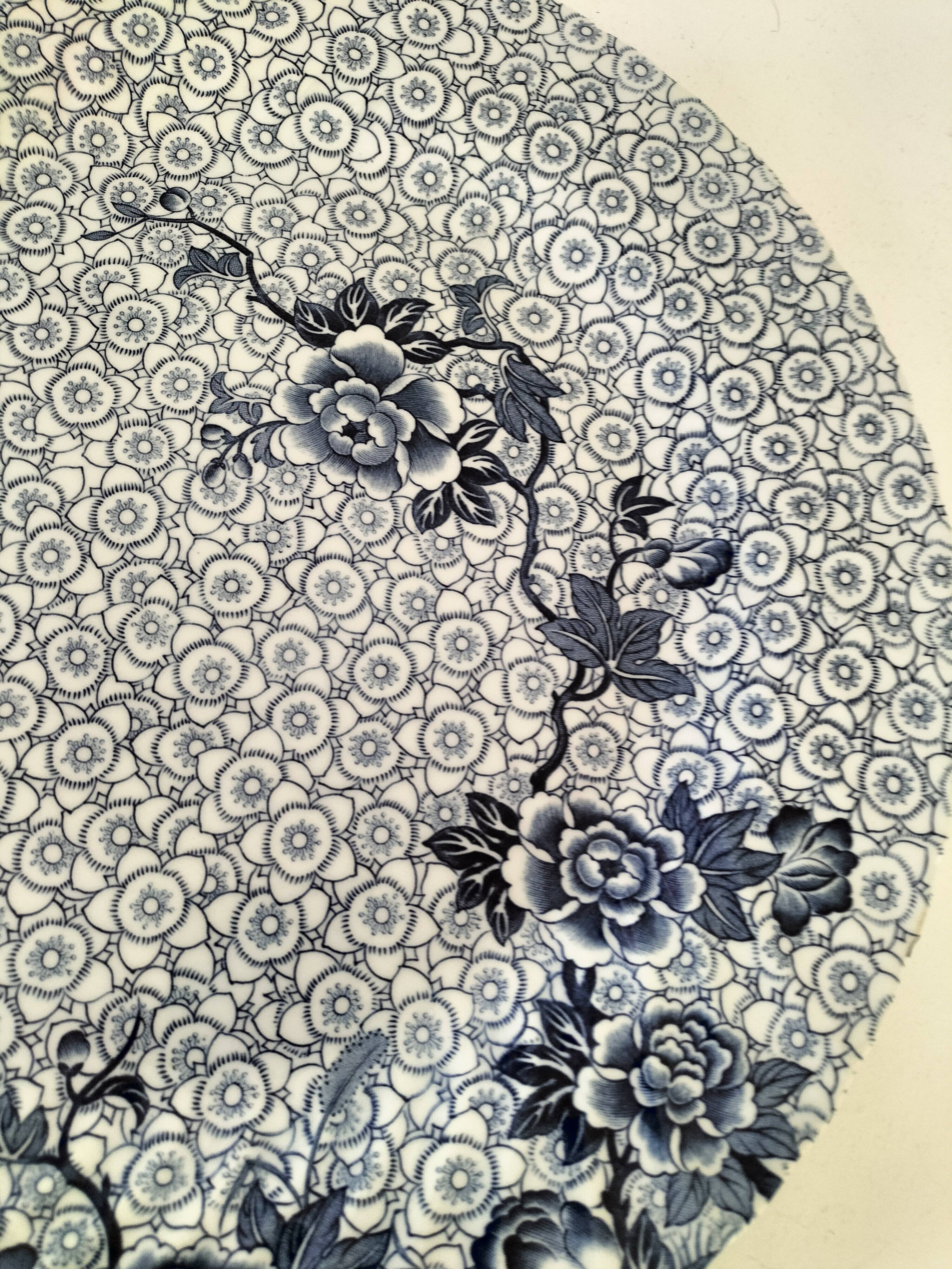 Round antique plate by Johnson Brothers in the Blue Lotus pattern.