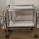 Vintage 1970s rolling dessert trolley in chrome metal and mirrored glass.