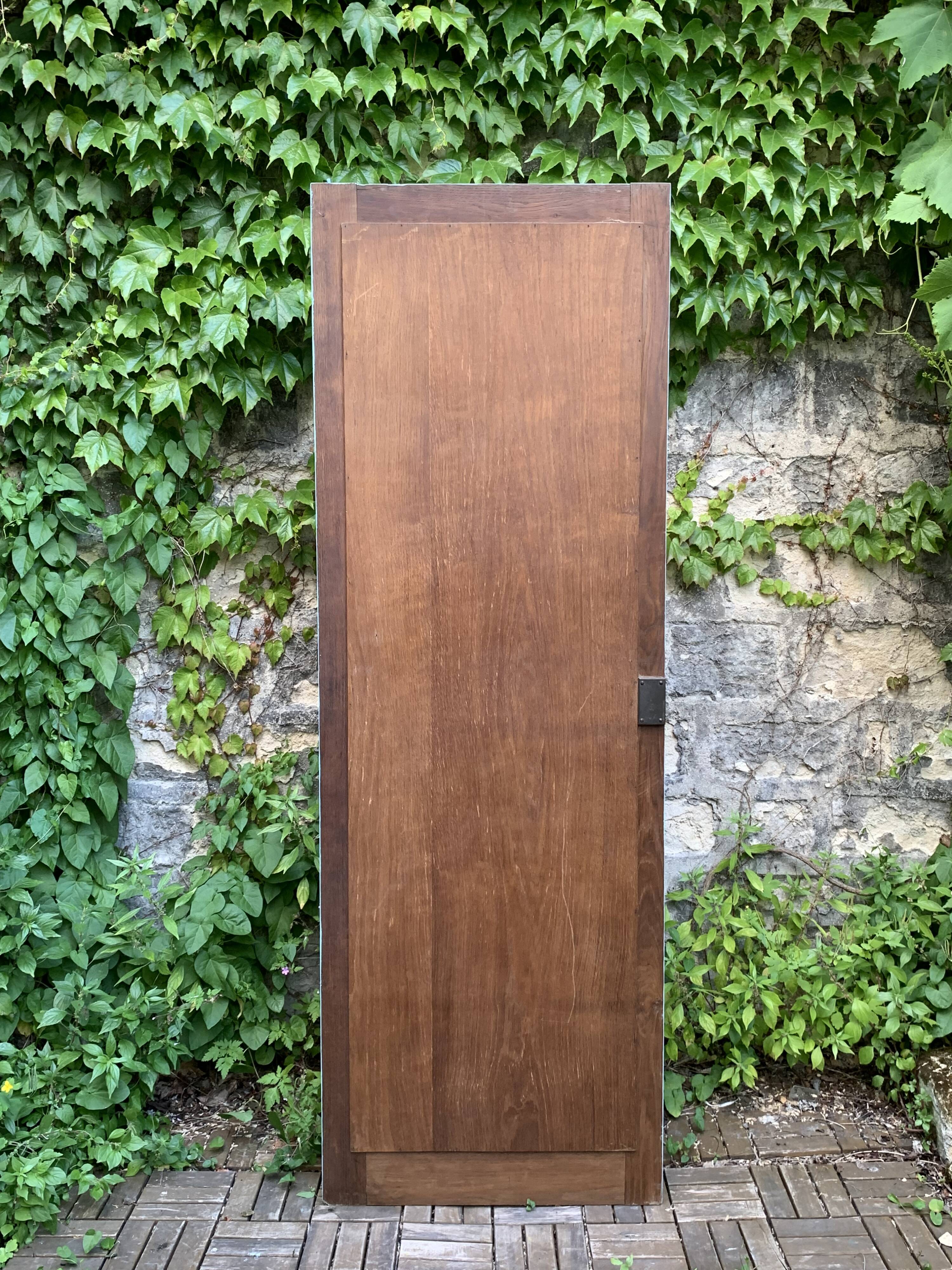 Beveled mirror on turquoise Parisian door